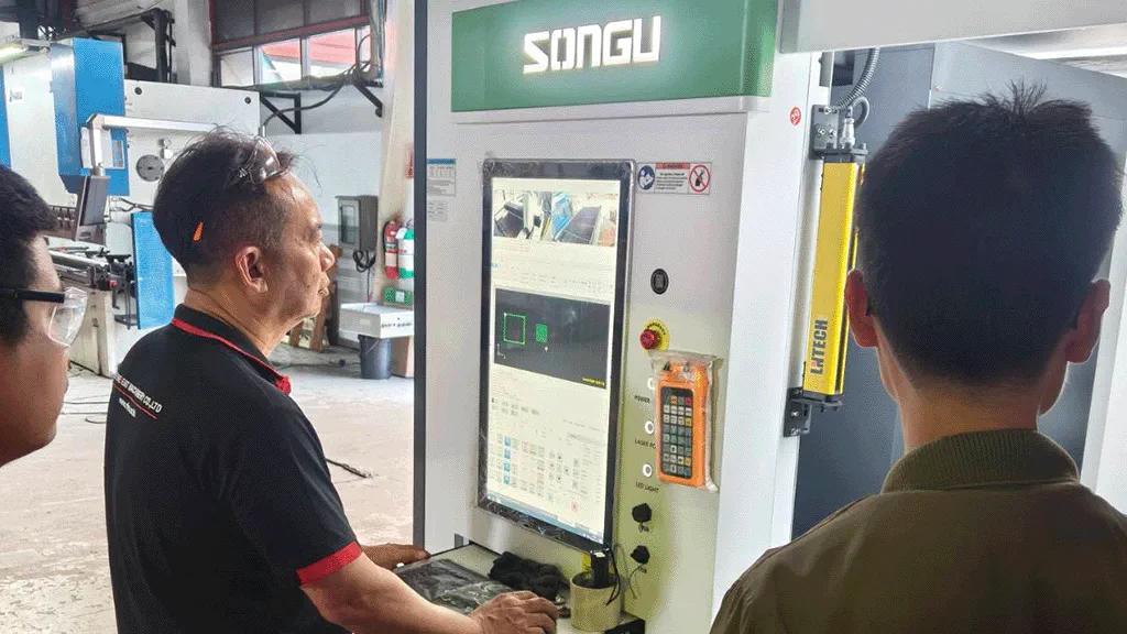 Photo of engineer operating at control station of fiber laser cutting machine